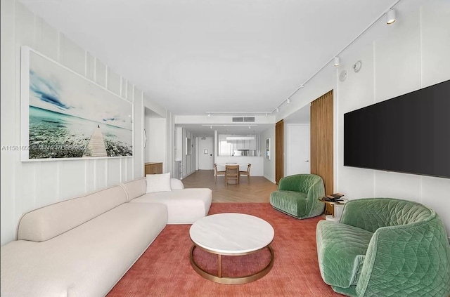 living room with parquet floors and track lighting