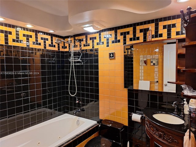 full bathroom with tiled shower / bath, vanity, toilet, and tile walls