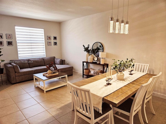 tiled dining space with a textured ceiling