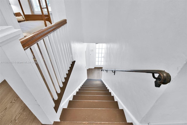 stairway featuring dark hardwood / wood-style floors