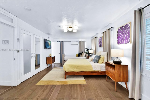 bedroom featuring hardwood / wood-style flooring and french doors