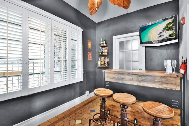 bar with tile floors and ceiling fan