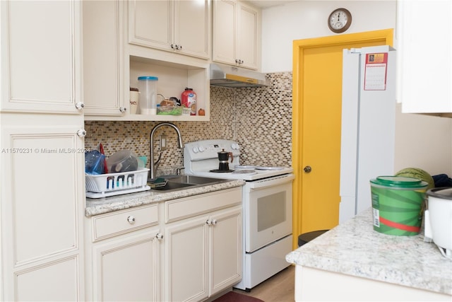 kitchen with white electric range oven, decorative backsplash, and sink