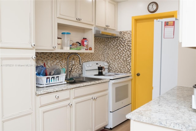 kitchen featuring electric range, tasteful backsplash, and sink