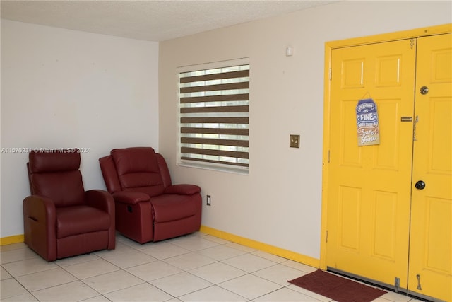 foyer featuring light tile patterned floors and a textured ceiling