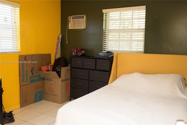 bedroom featuring a wall unit AC and light tile patterned flooring