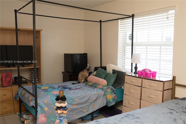 tiled bedroom featuring multiple windows