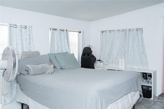 tiled bedroom featuring ornamental molding