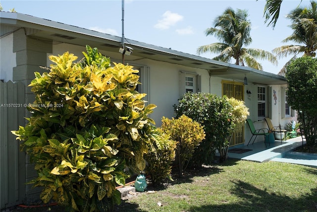 view of property exterior with a yard