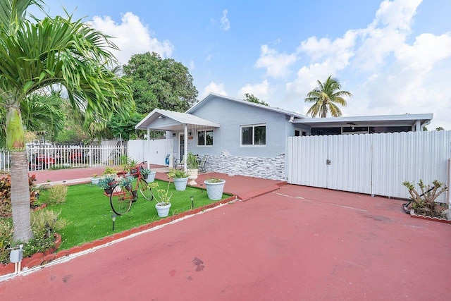 view of front of house with a front yard and a patio area