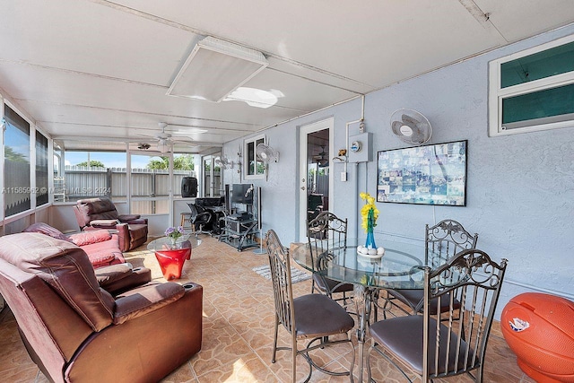 sunroom / solarium featuring ceiling fan