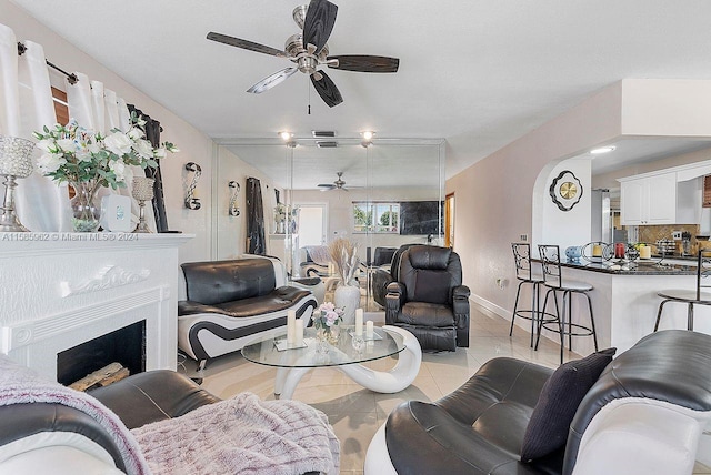 tiled living room featuring ceiling fan