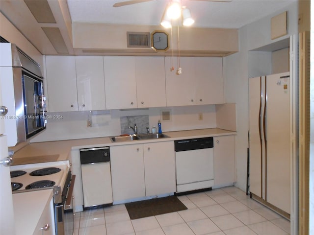 kitchen with white appliances, visible vents, light countertops, and a sink