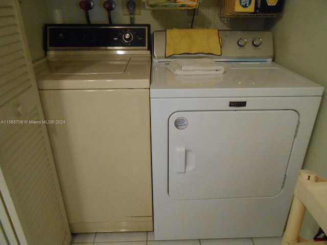 laundry area featuring washing machine and dryer, laundry area, and light tile patterned floors