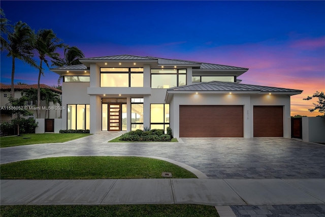 view of front of house with french doors, a balcony, and a garage