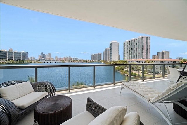 balcony featuring outdoor lounge area and a water view