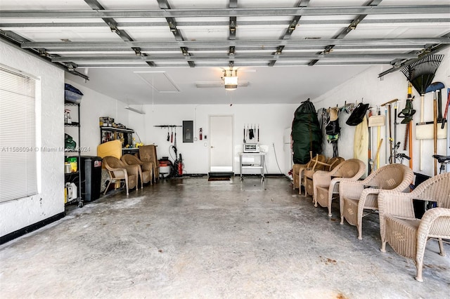 garage with a garage door opener and electric panel