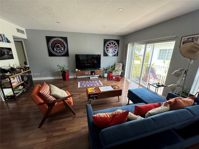 living room with a textured ceiling and hardwood / wood-style flooring