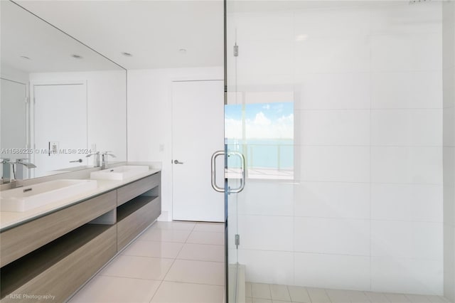 bathroom featuring tile walls, tile flooring, large vanity, and dual sinks