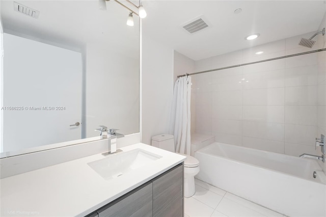 full bathroom featuring tile floors, shower / bath combination with curtain, vanity, and toilet