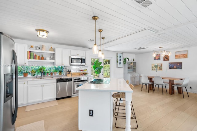 kitchen featuring wooden ceiling, light hardwood / wood-style flooring, pendant lighting, and appliances with stainless steel finishes