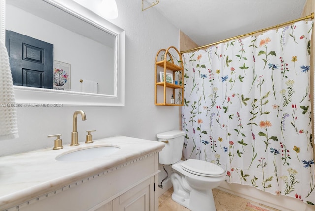 bathroom with tile flooring, vanity, and toilet