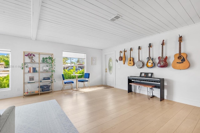 miscellaneous room featuring beamed ceiling, plenty of natural light, light wood-type flooring, and wood ceiling