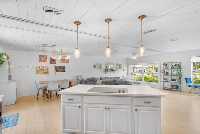 kitchen featuring hanging light fixtures, light hardwood / wood-style floors, and black electric cooktop