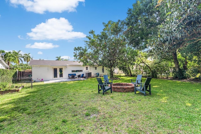 view of yard featuring a patio area, central AC unit, and a fire pit