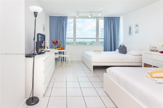 tiled bedroom with rail lighting