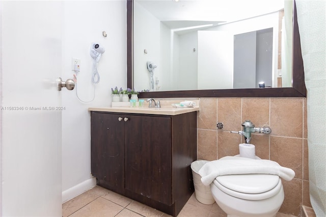 bathroom featuring tile floors, tile walls, toilet, and vanity