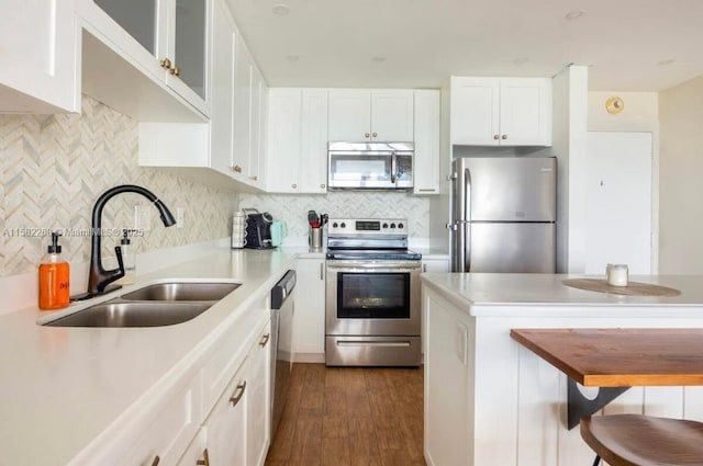 kitchen with white cabinetry, decorative backsplash, sink, and appliances with stainless steel finishes