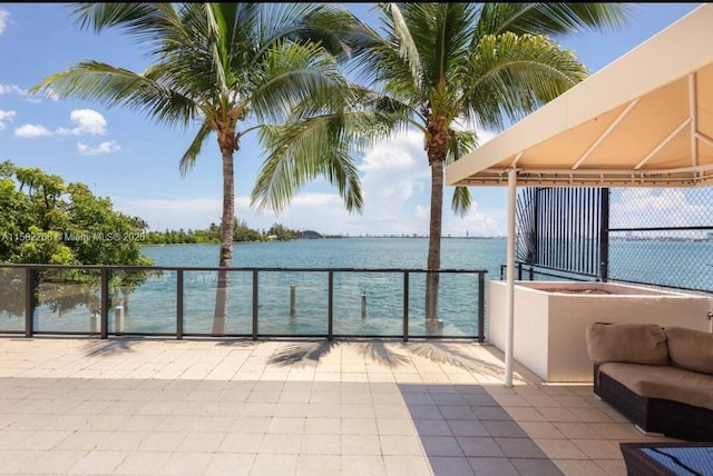 view of patio / terrace featuring a water view and a balcony