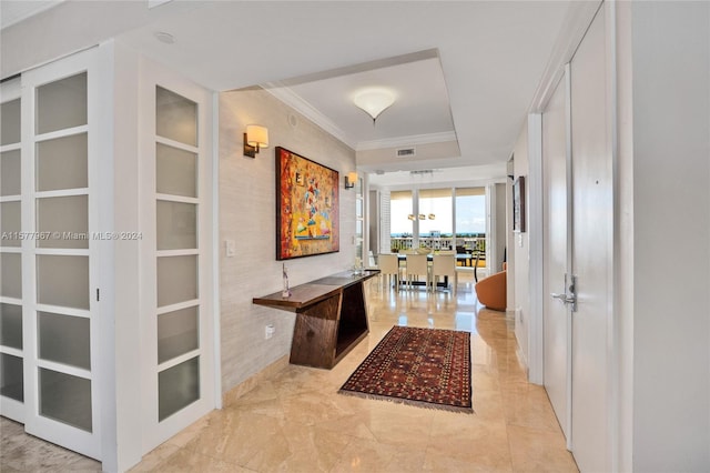 corridor with ornamental molding, light tile patterned flooring, and built in shelves