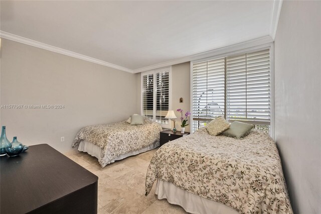 bedroom with light tile patterned flooring and crown molding