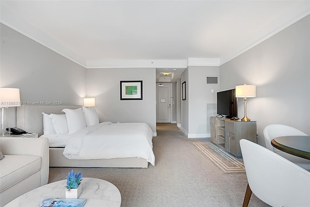 bedroom featuring carpet flooring and ornamental molding