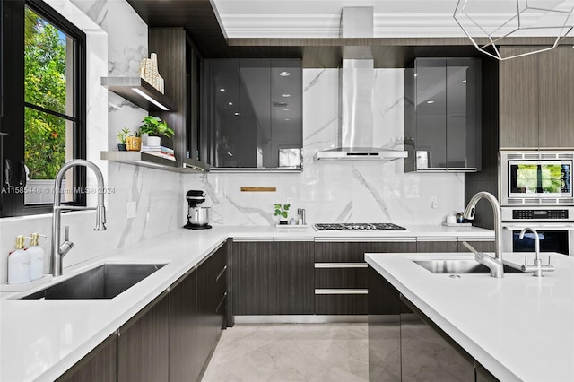 kitchen featuring wall chimney range hood, light tile flooring, stainless steel appliances, backsplash, and sink