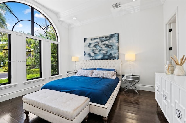 bedroom featuring dark hardwood / wood-style flooring and crown molding