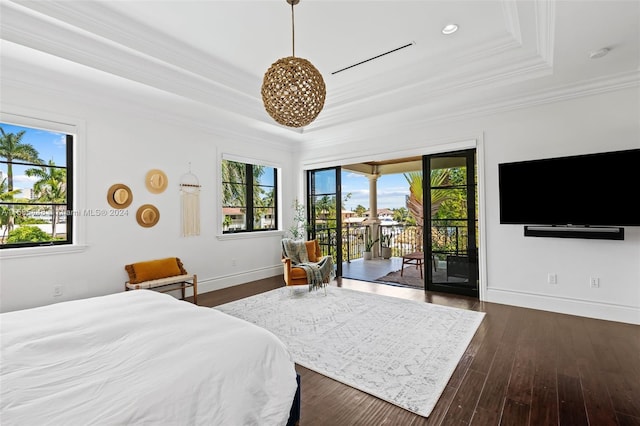 bedroom with access to outside, a tray ceiling, dark hardwood / wood-style floors, and crown molding