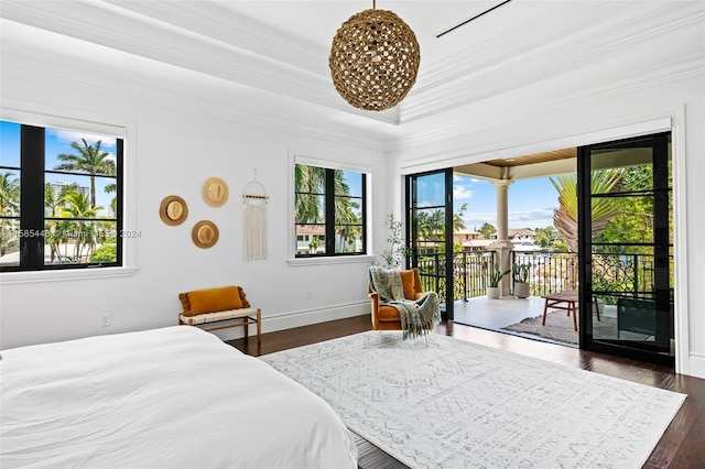 bedroom featuring dark hardwood / wood-style floors, a tray ceiling, a chandelier, access to exterior, and ornamental molding