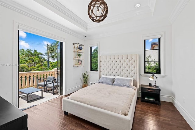 bedroom with access to outside, ornamental molding, dark hardwood / wood-style floors, and a raised ceiling