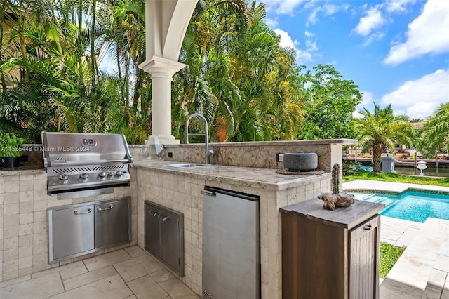 view of patio / terrace featuring sink, exterior kitchen, and grilling area