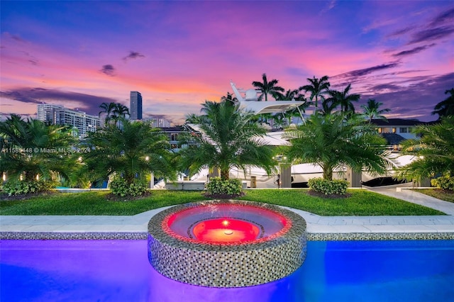 view of pool at dusk