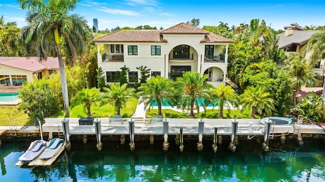 back of house featuring a water view and a balcony