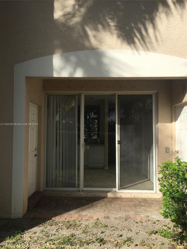 doorway to property with stucco siding