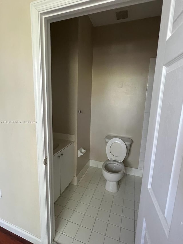 bathroom featuring visible vents, toilet, vanity, tile patterned flooring, and baseboards