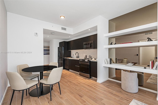 interior space featuring black fridge with ice dispenser, light hardwood / wood-style flooring, backsplash, electric range oven, and sink