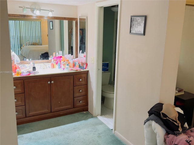 bathroom featuring vanity and toilet