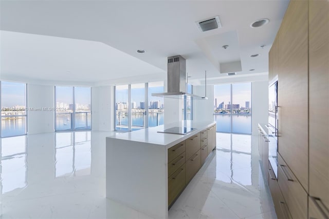 kitchen with black electric stovetop, island exhaust hood, a wealth of natural light, and light tile floors