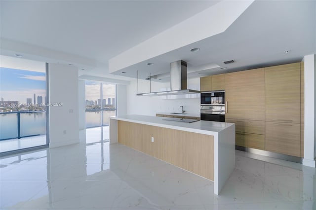 kitchen featuring a center island, stainless steel double oven, light tile floors, and island exhaust hood